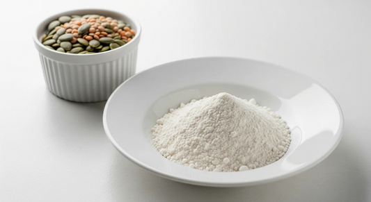 White bowl with flour and small container of mixed seeds on a white background