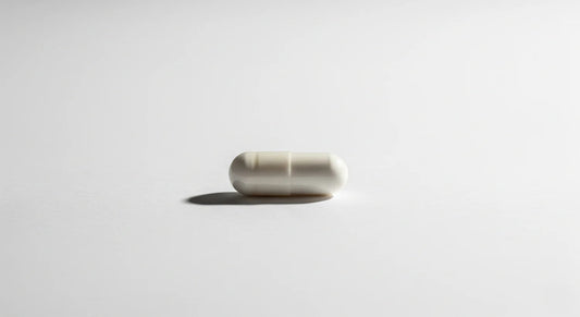 White capsule pill on a light gray background