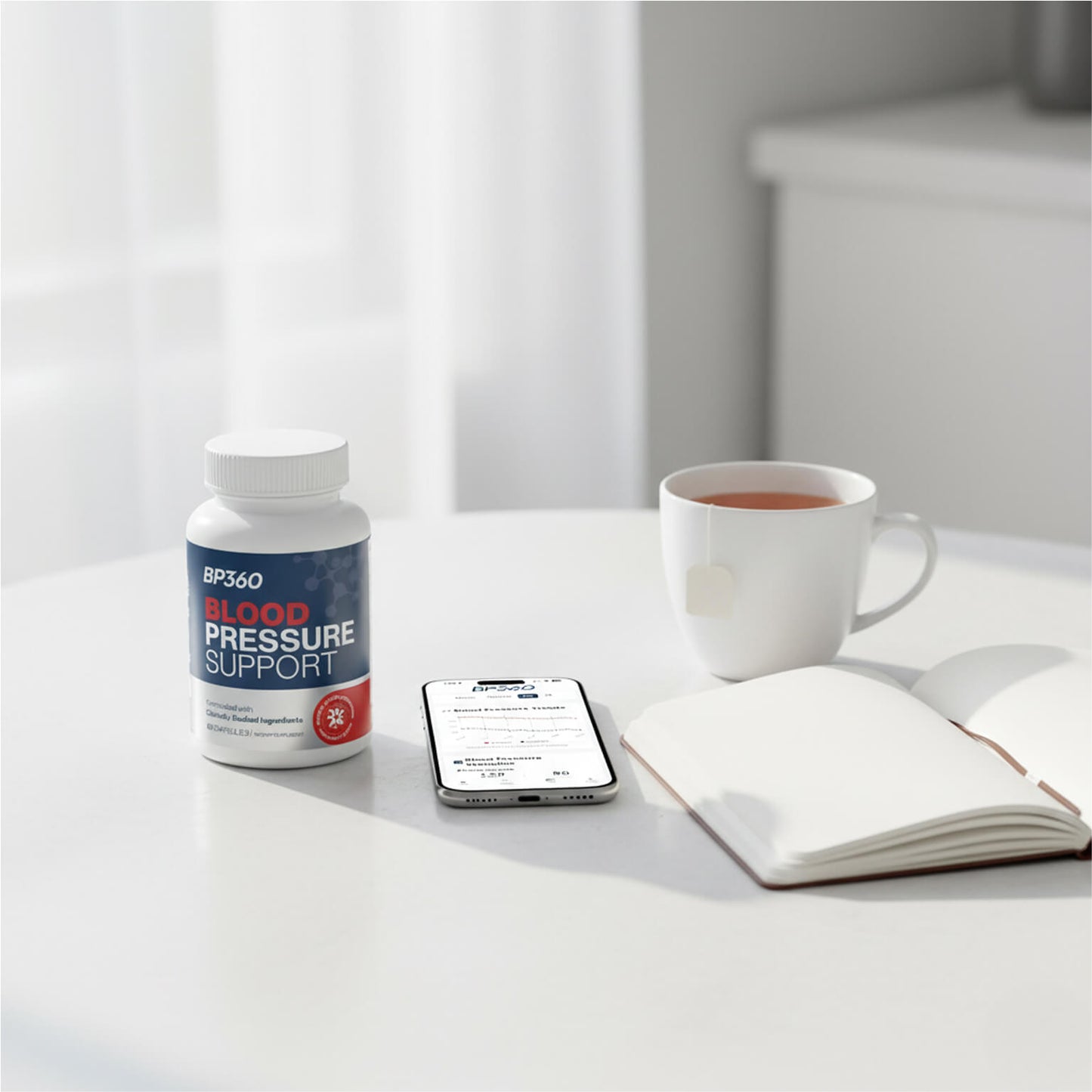 Bottle of BP2GO Blood Pressure Support on a table with a phone, mug, and notebook.