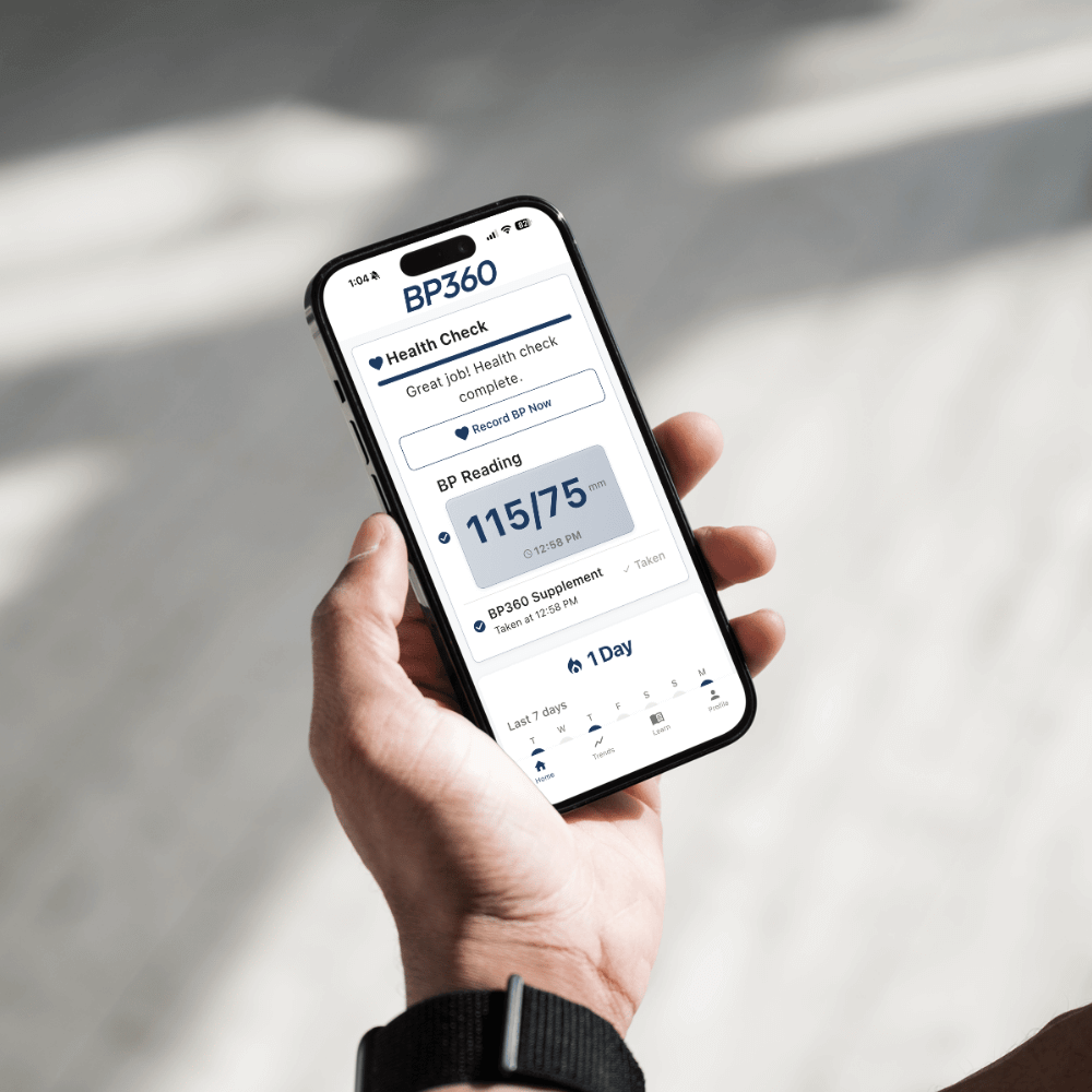 Hand holding a smartphone displaying the BP360 app.