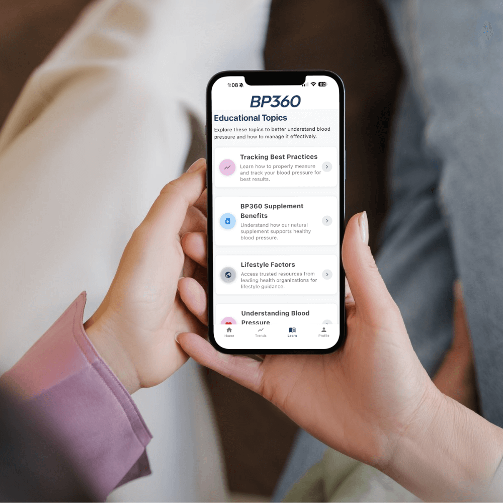 Person holding a smartphone displaying the BP360 app with educational topics on the screen.